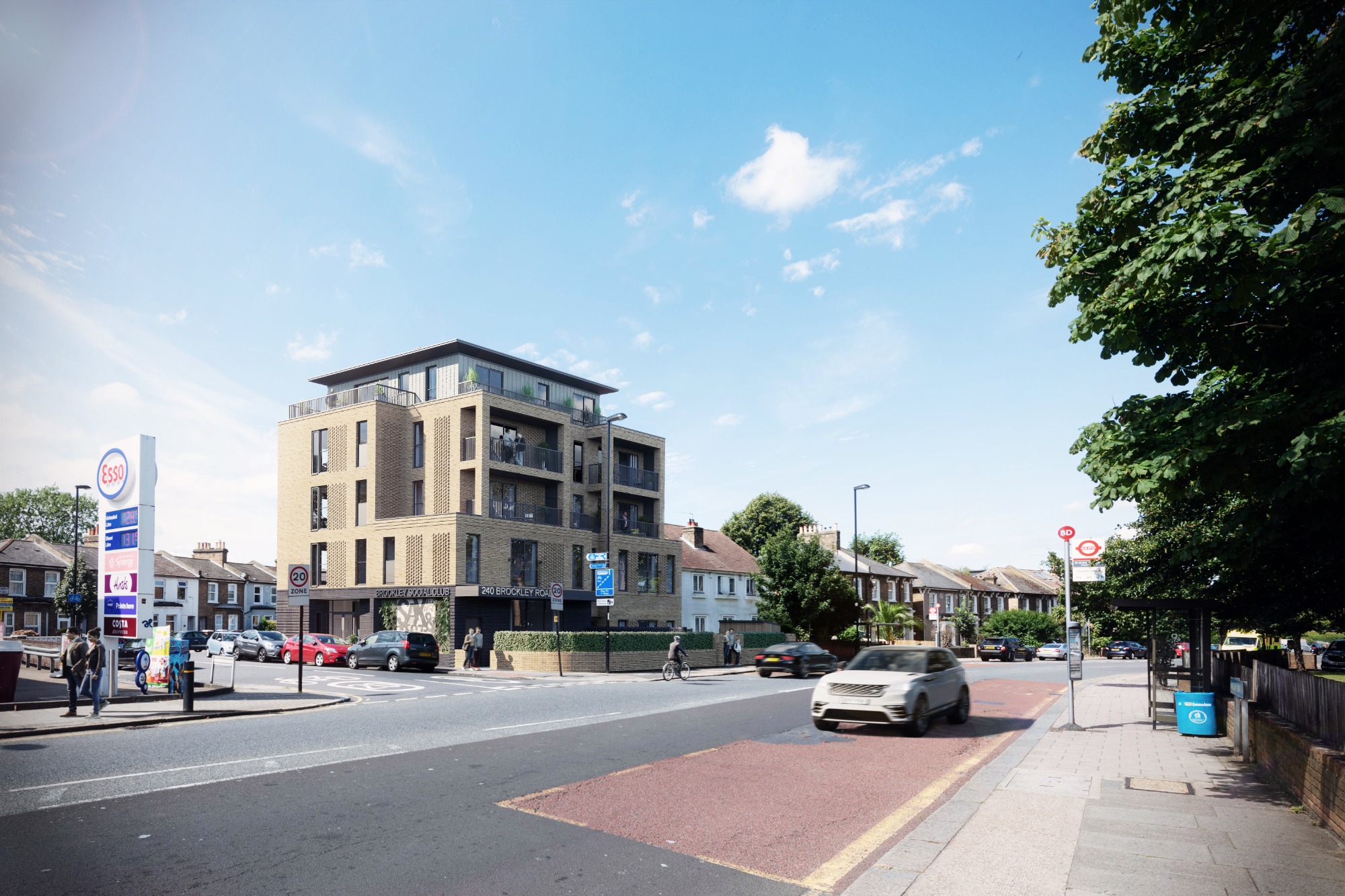 Brockley Social Club Modern multi-storey building on a sunny street with traffic and trees.
