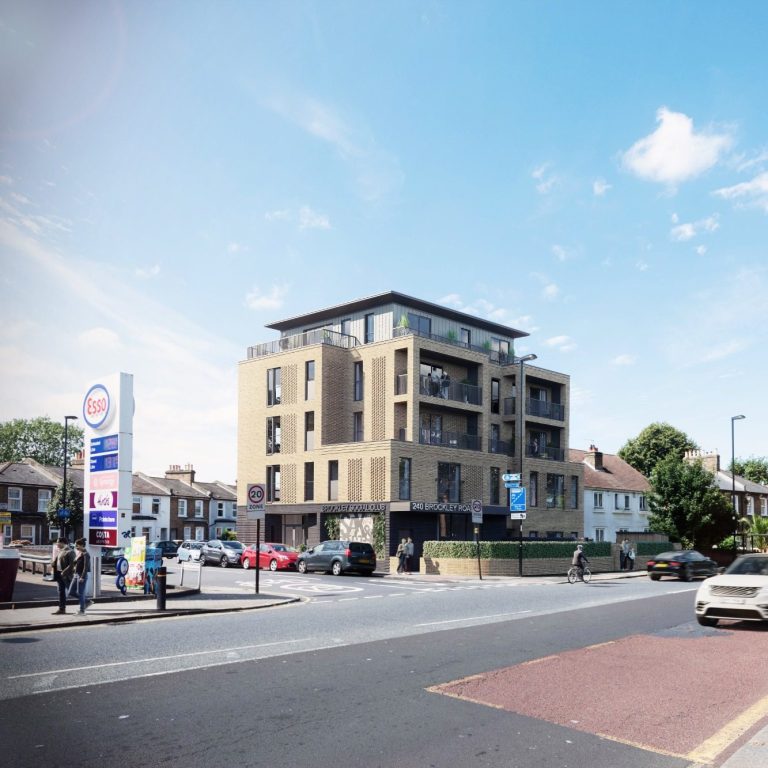 contemporary flats and social club in Brockley Modern brick building with a flat roof and parking, viewed from a street with blue sky.