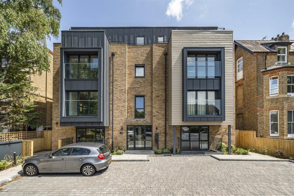 The Avenue, Surbiton Modern three-storey building with large windows and a parked car in front.
