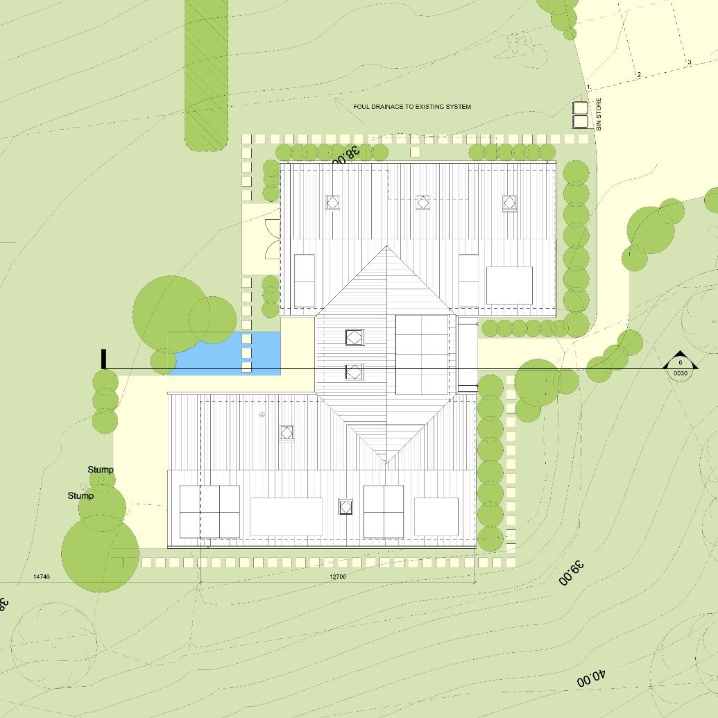 Site plan showing a building layout, parking area, gardens, and pathways.